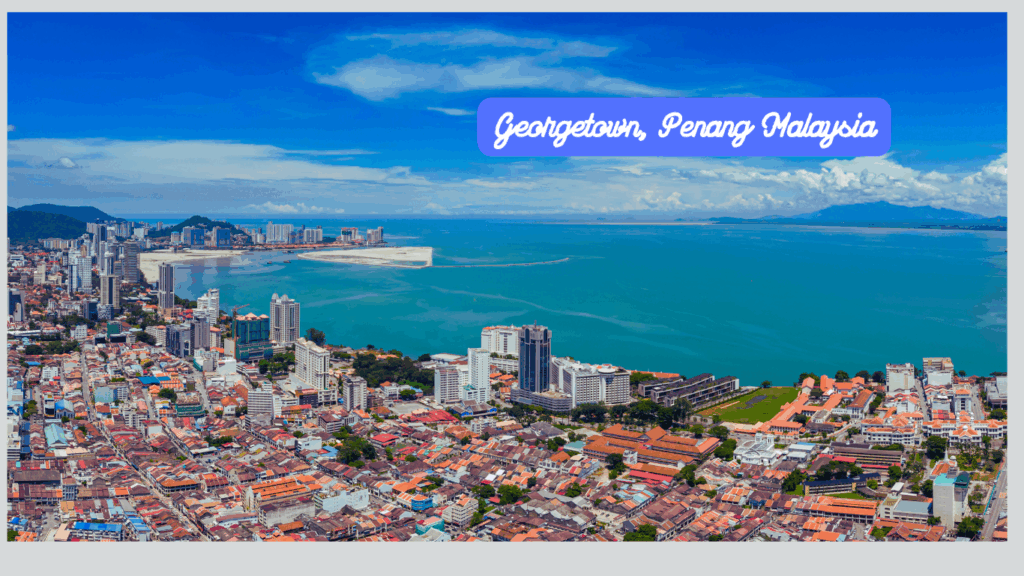 Aerial view of George Town, Penang with the sea in the background, captured during a visa run journey between Thailand and Malaysia.