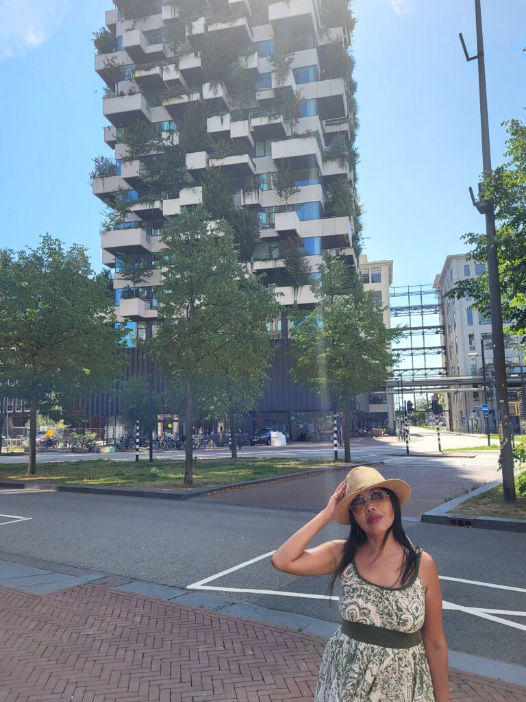 Trudo Toren in Eindhoven’s Strijp-S district with a visitor posing in front of the vertical forest towe